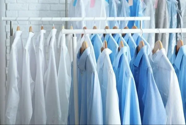 Pressed shirts hanging in rows on a rail