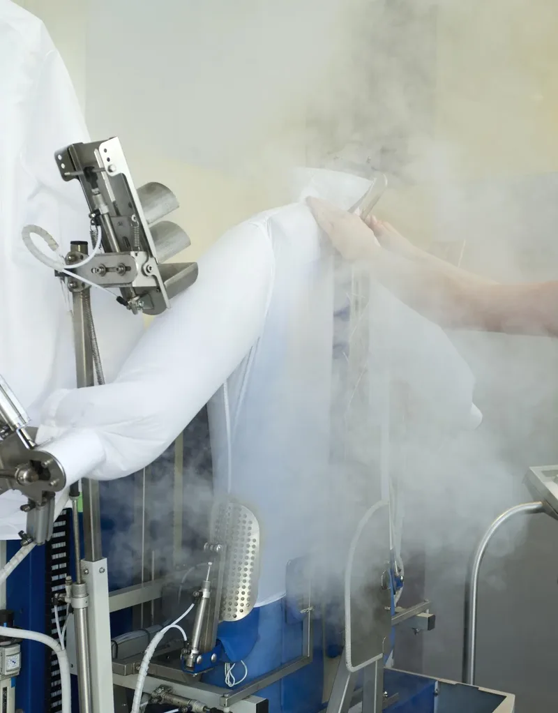 A garment being steam finished on a press